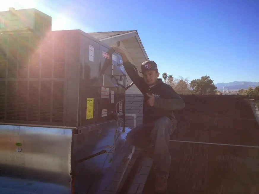 HVAC technician performing AC Tune-Up on a rooftop unit in Gun Barrel City